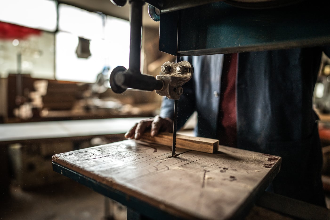 Close-up of a carpenter using sander to cutting piece of wood